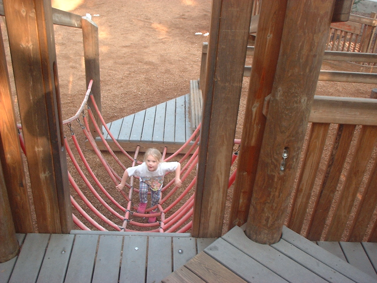 child playing on playground structurek